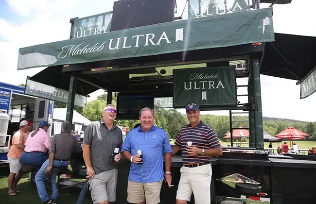 three men in front of stage