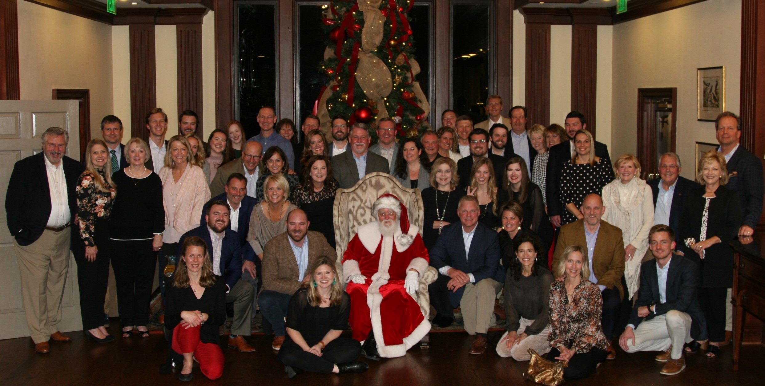 staff picture with santa celebrating the holidays