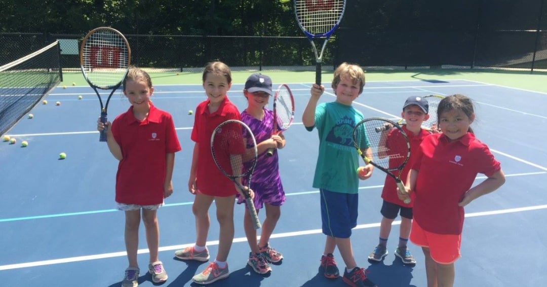 kids playing tennis at summer camp at greystone golf and country club